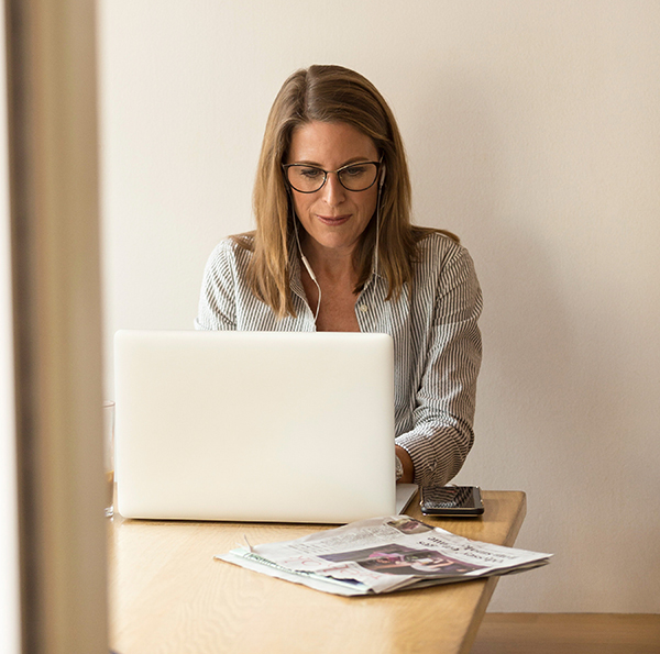 Business woman using her laptop to connect via Zoom for an online session
