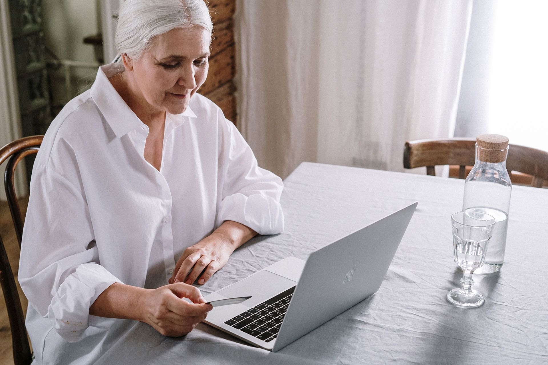 Senior woman using a laptop to connect